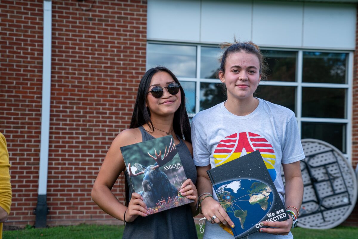 two female students holding books