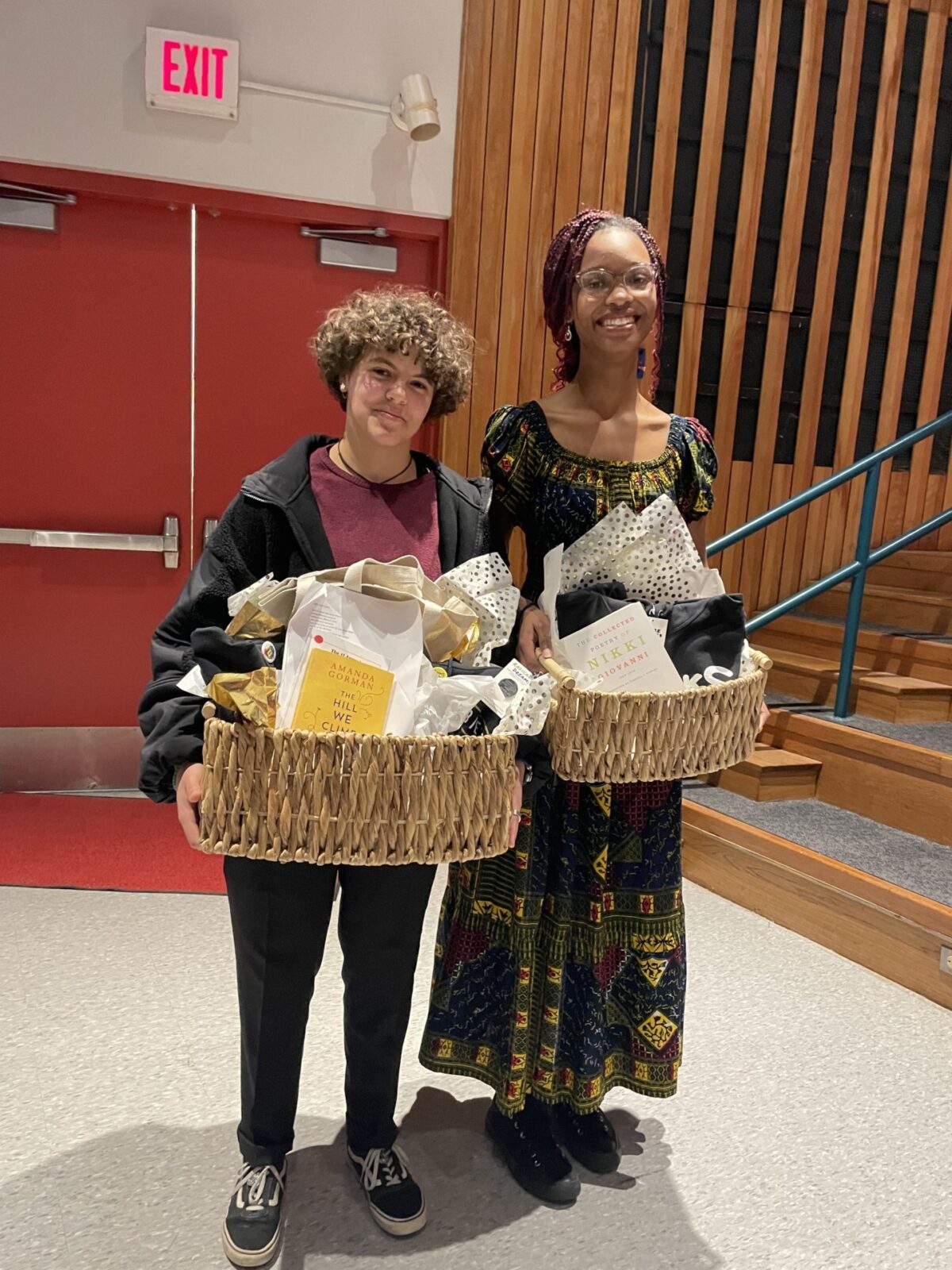 two students with gift baskets