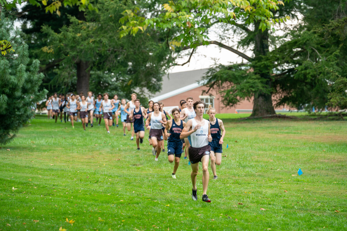 Boys Cross Country team running on the grass