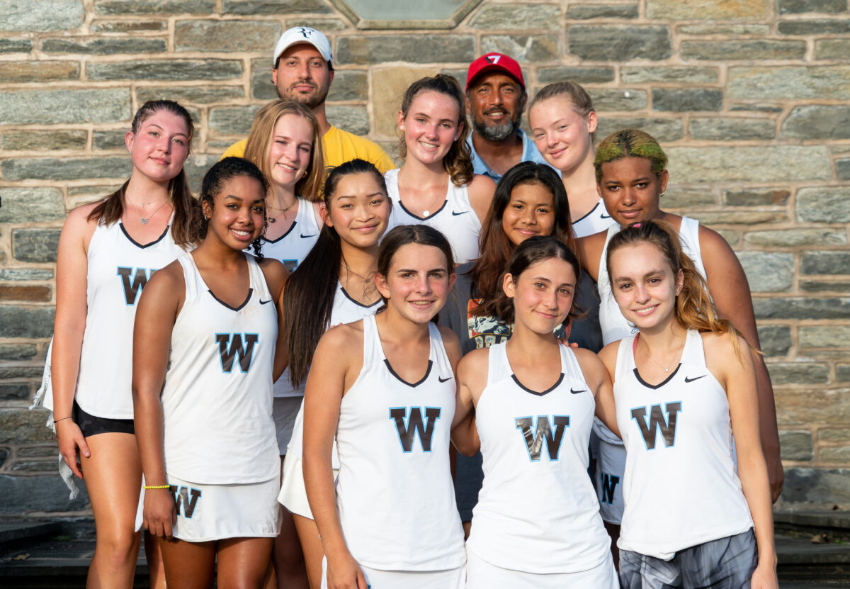 Girls Tennis team posing with coaches