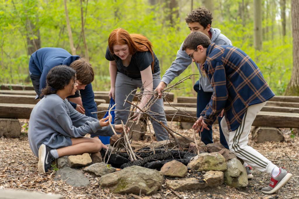 Middle Schoolers build a fire.